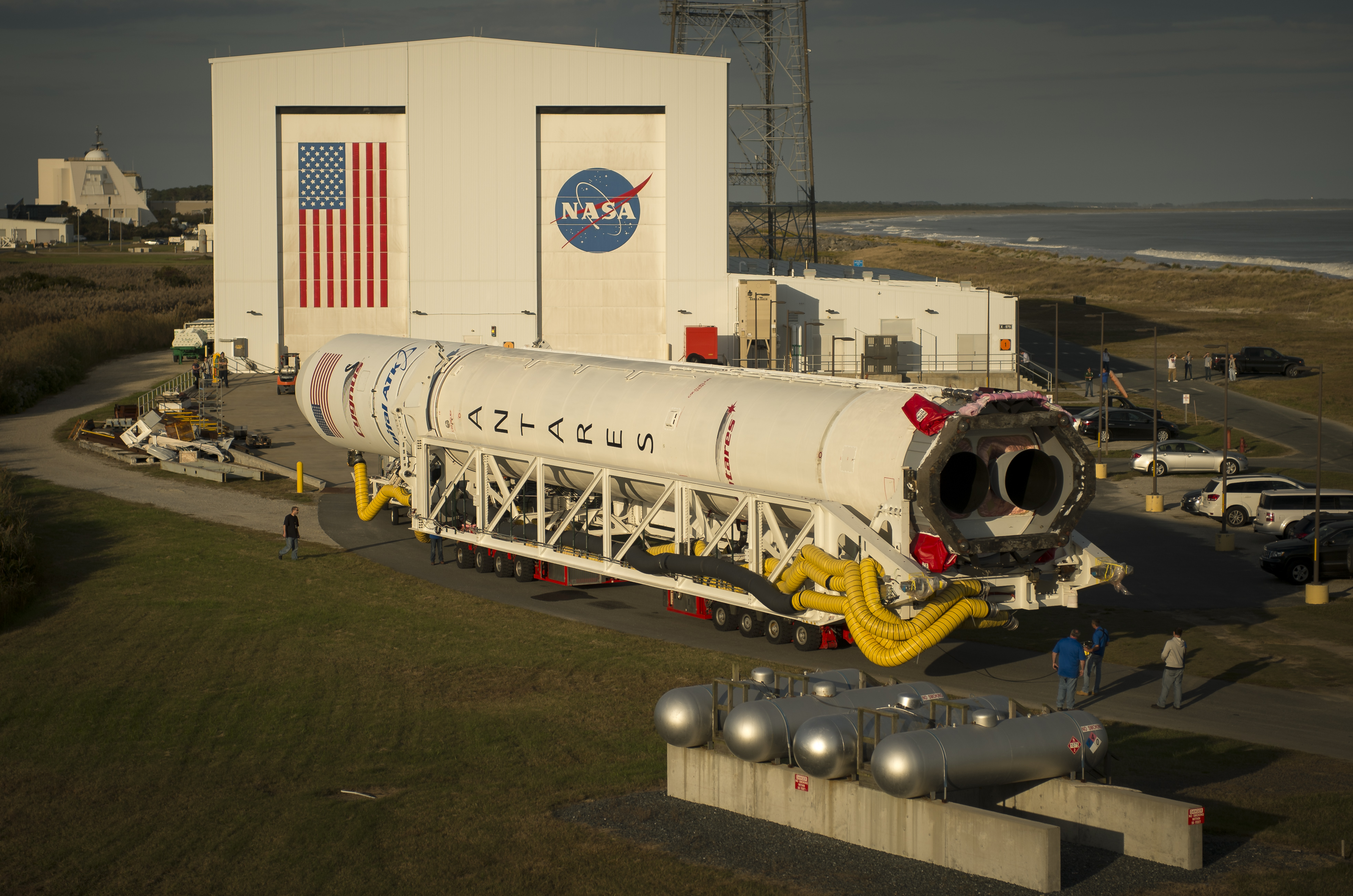 The Orbital ATK Antares rocket, with the Cygnus spacecraft onboard, is rolled out of the Horizontal Integration Facility (HIF) to begin the approximately half-mile journey to launch Pad-0A, Thursday, Oct. 13, 2016 at NASA's Wallops Flight Facility in Virginia. Orbital ATK’s sixth contracted cargo resupply mission with NASA to the International Space Station will deliver over 5,100 pounds of science and research, crew supplies and vehicle hardware to the orbital laboratory and its crew. Photo Credit: (NASA/Bill Ingalls)